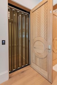 Accordion Gate with bronze tinted acrylic panels.